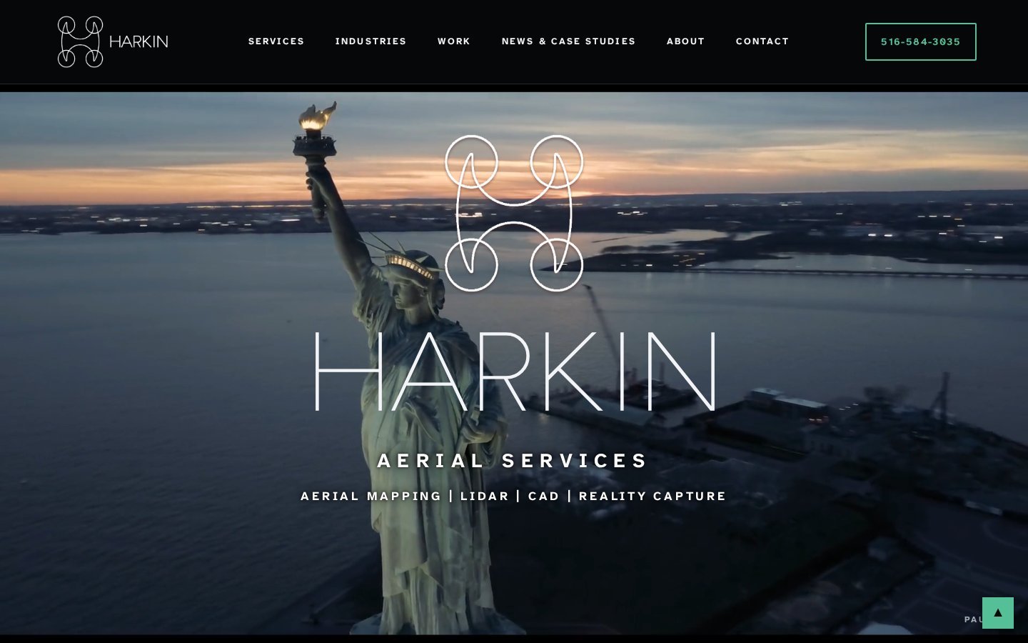 The Harkin Aerial Services home page: aerial view of the Statue of Liberty at dusk with the HARKIN logo